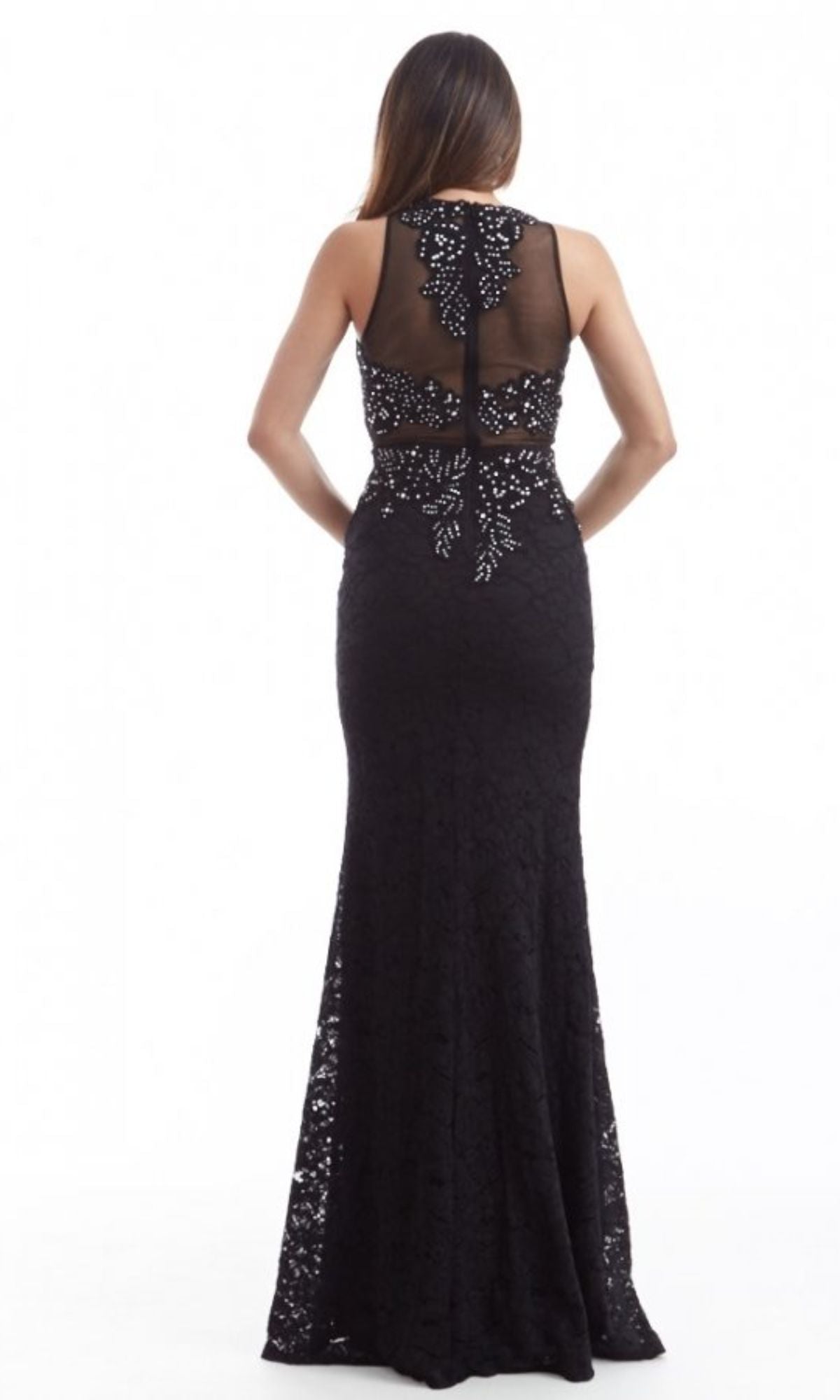 A woman faces away, wearing the Chicas CR4225 Mock Two-Piece Long Lace Prom Dress—black embroidered lace, floor-length silhouette, sheer back panel, and decorative beading.